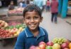 "A teenage boy selling fruits at a street stall in a busy African city."