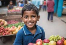 "A teenage boy selling fruits at a street stall in a busy African city."