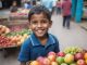 "A teenage boy selling fruits at a street stall in a busy African city."