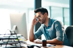 Entrepreneur looking discouraged while reviewing sales data