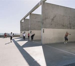 A visual of sand turning into a silicon ingot (large shiny cylinder)